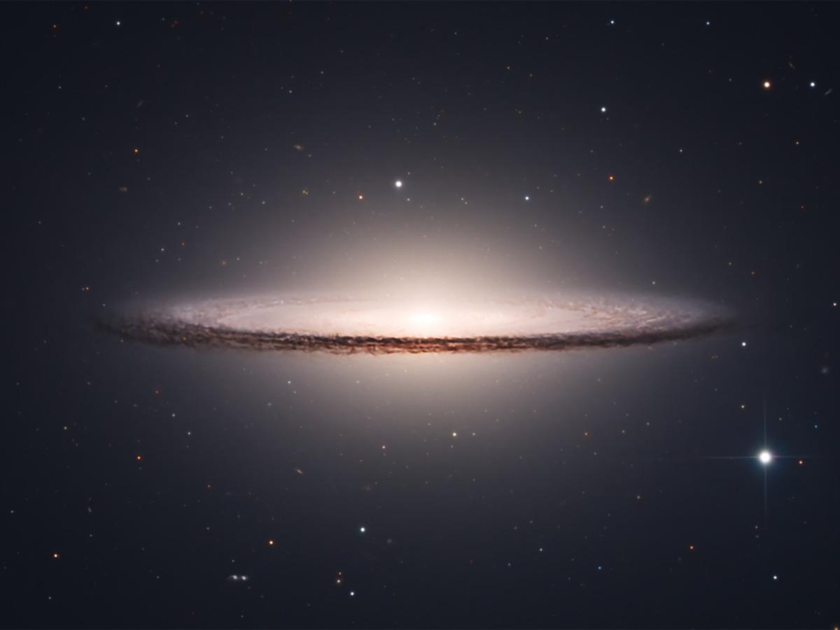 Close-up of the Sombrero Galaxy, its bright central bulge cut by the sharp dark dust lane along the edge-on disc