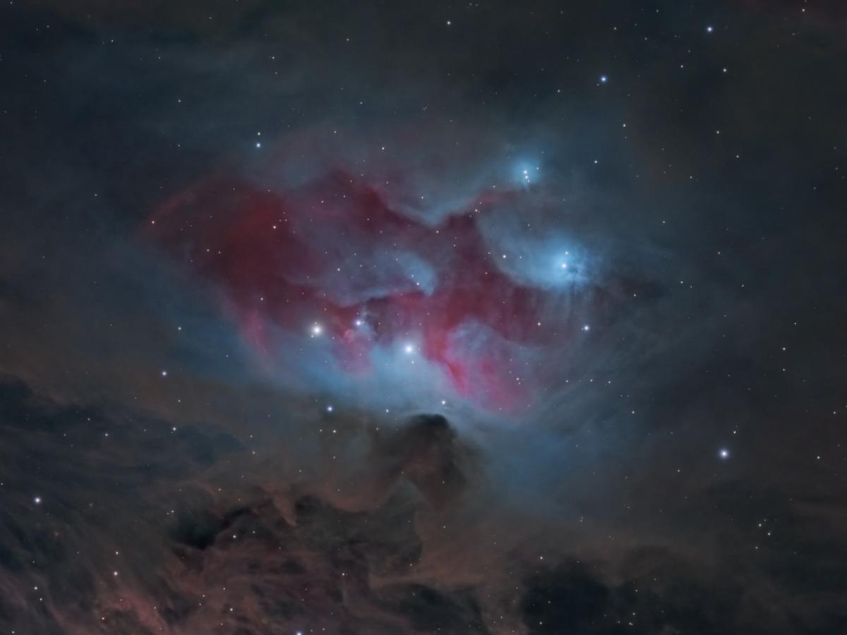 Close-up of the region just north of M42's core, the blue reflection nebulosity of the Running Man (NGC 1977) set above the dark 'fish's mouth' dust lane